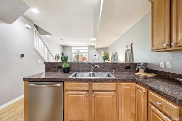 3030 Wyandot St Unit 4, Denver, CO 80211 - kitchen featuring dishwasher, a sink, light wood-style flooring, a textured wall, and baseboards