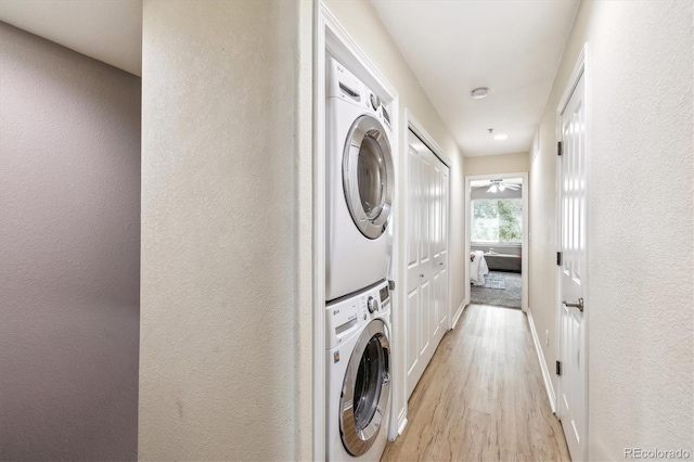 3030 Wyandot St Unit 4, Denver, CO 80211 - laundry area featuring stacked washer / drying machine, light wood-style flooring, baseboards, and a textured wall