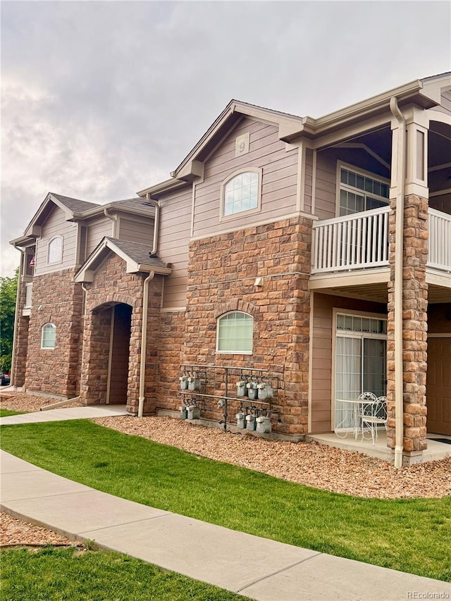 7440 S Blackhawk St Unit 9-108, Englewood, CO 80112 - view of front of home with a balcony and stone siding
