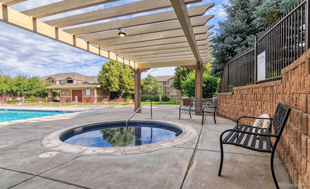 7440 S Blackhawk St Unit 9-108, Englewood, CO 80112 - community pool with a hot tub, a pergola, and a patio