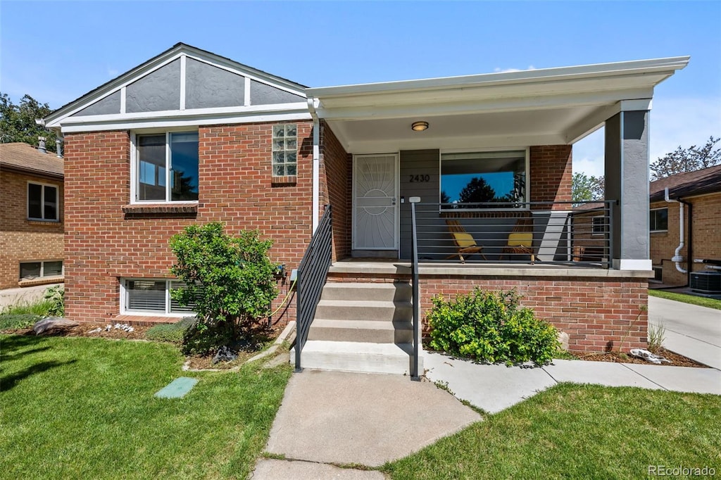2430 S Ogden St, Denver, CO 80210 - view of front facade with brick siding and a front yard