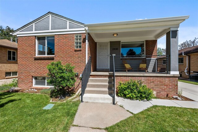2430 S Ogden St, Denver, CO 80210 - view of front facade with brick siding and a front yard