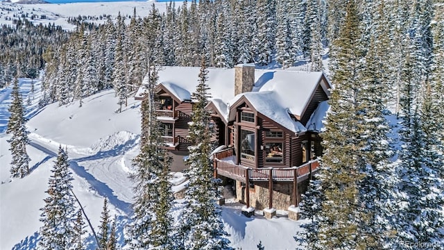 snowy aerial view featuring a mountain view