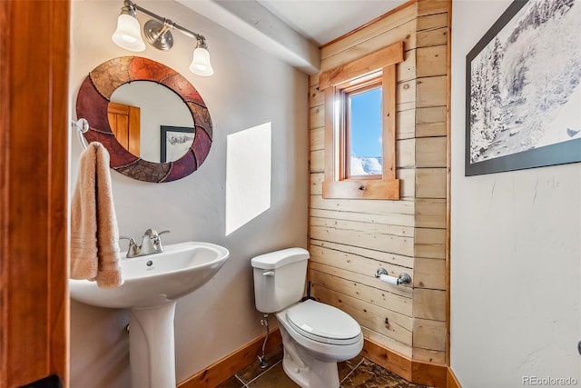 bathroom with toilet and baseboards