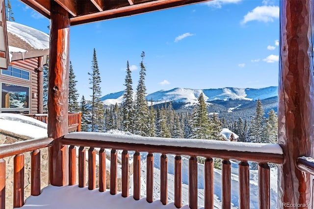 snow covered deck featuring a mountain view