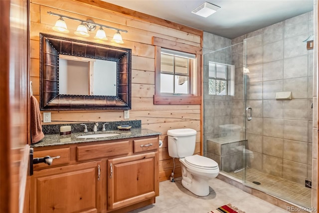 bathroom featuring toilet, tile patterned flooring, visible vents, and a stall shower