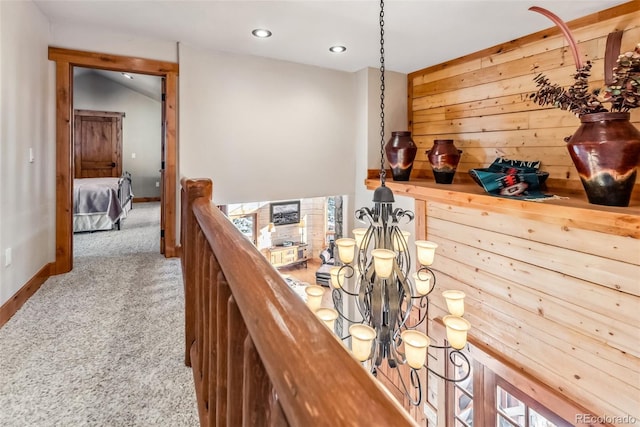 corridor featuring carpet floors, baseboards, an upstairs landing, and recessed lighting
