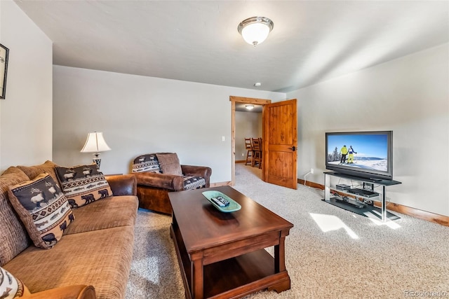 carpeted living room featuring baseboards