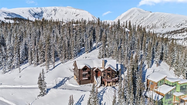snowy aerial view with a mountain view