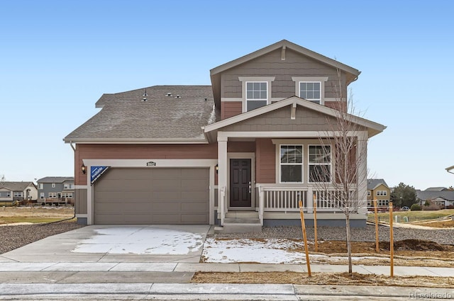 view of front of home with a porch and a garage