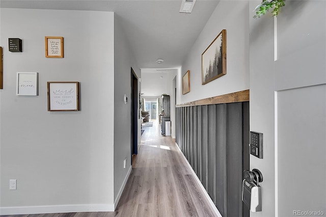 corridor with light hardwood / wood-style floors