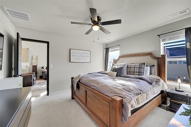 bedroom with ceiling fan and light carpet