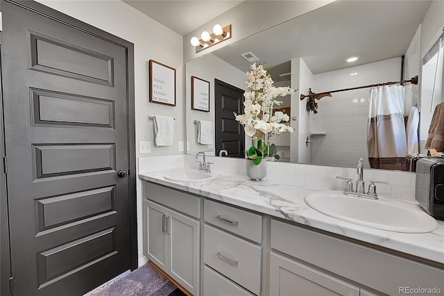 bathroom featuring vanity and a shower with shower curtain