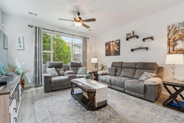 living room with hardwood / wood-style floors and ceiling fan