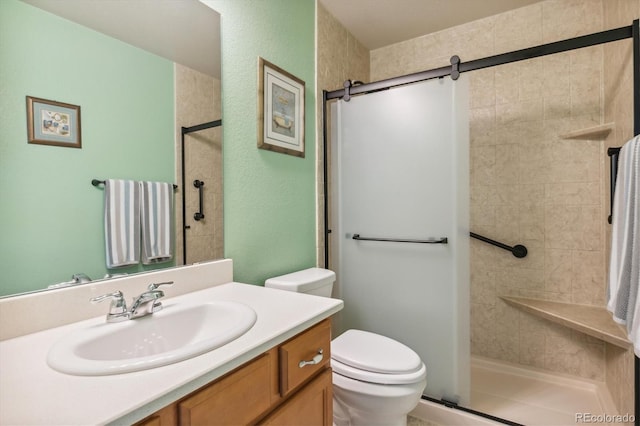 bathroom featuring vanity, toilet, and a tile shower