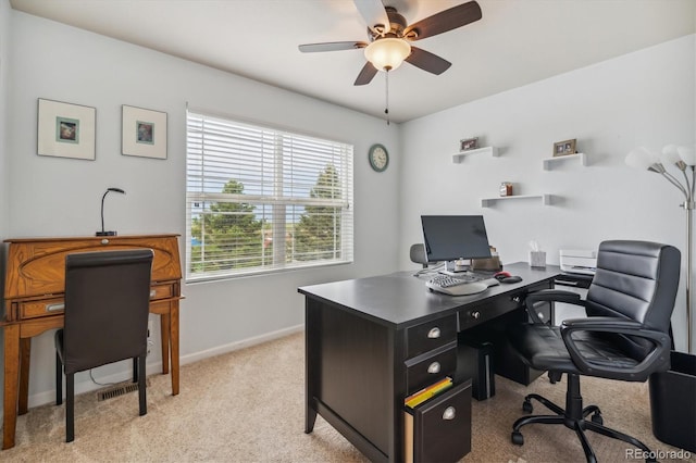 carpeted home office featuring ceiling fan