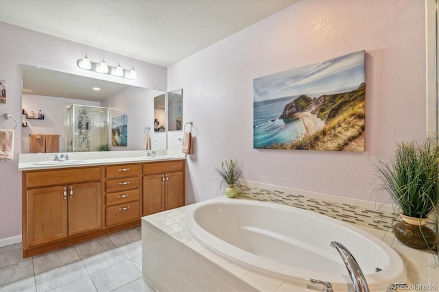 bathroom featuring tile patterned flooring, vanity, shower with separate bathtub, and a textured ceiling