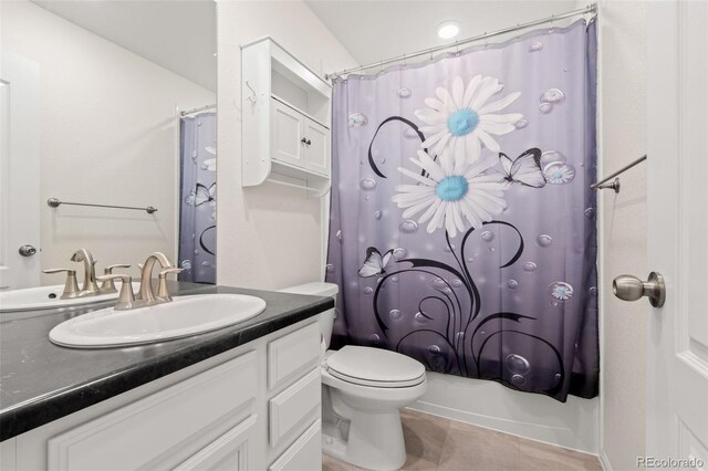 bathroom with toilet, vanity, shower / bath combo with shower curtain, and tile patterned floors