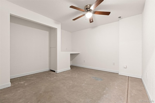 unfurnished bedroom with a ceiling fan, visible vents, baseboards, and unfinished concrete floors