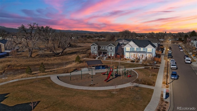 aerial view at dusk featuring a residential view