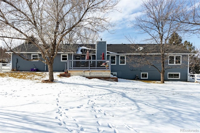 snow covered house with a chimney