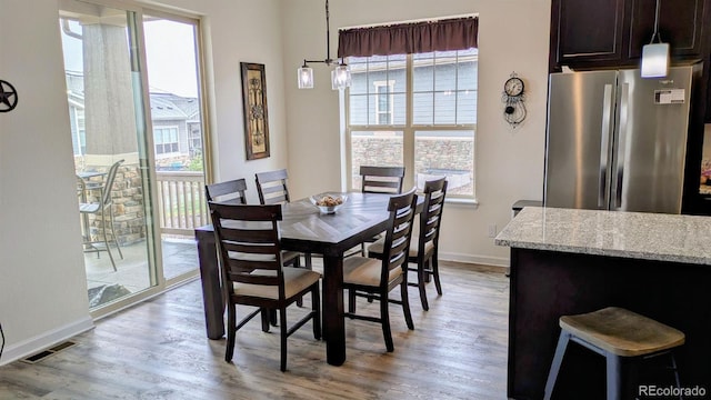 22345 E Bailey Pl, Aurora, CO 80016 - dining space featuring baseboards, light wood-type flooring, and visible vents