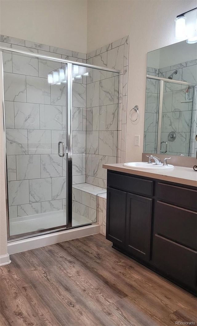 22345 E Bailey Pl, Aurora, CO 80016 - bathroom with vanity, wood finished floors, and a stall shower