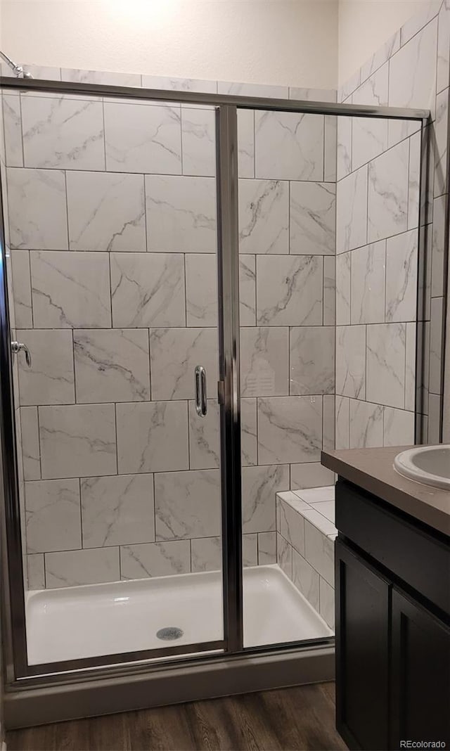 22345 E Bailey Pl, Aurora, CO 80016 - full bath featuring vanity, wood finished floors, and a shower stall