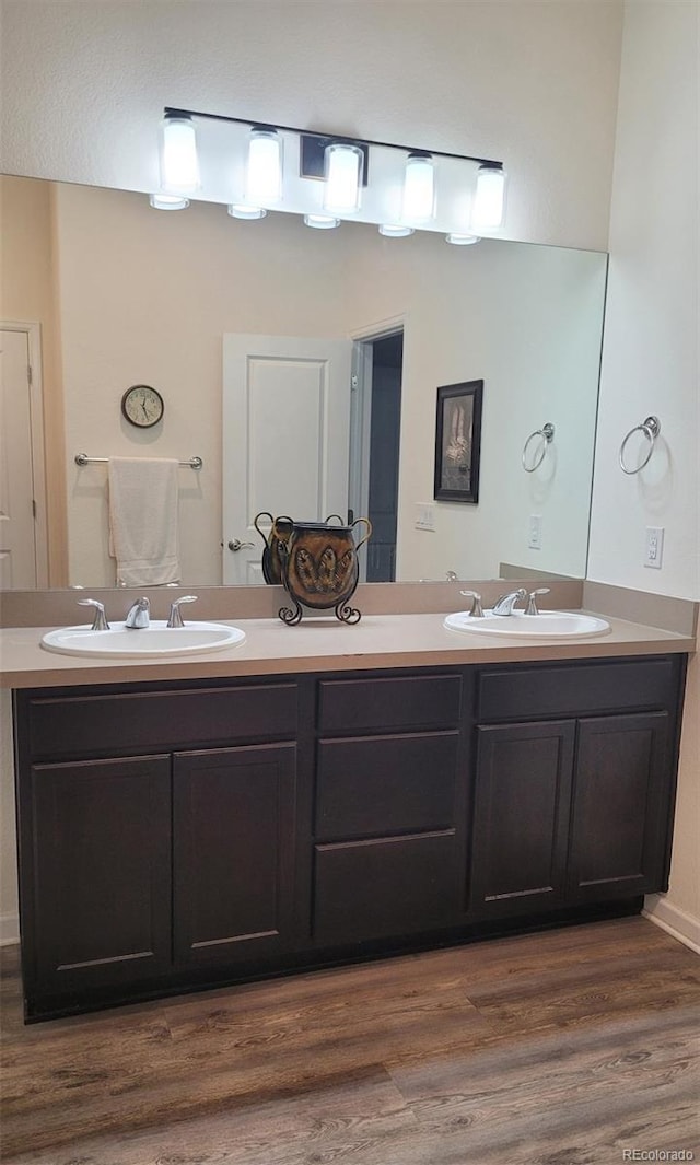 22345 E Bailey Pl, Aurora, CO 80016 - full bathroom featuring a sink, double vanity, and wood finished floors