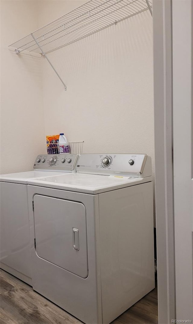 22345 E Bailey Pl, Aurora, CO 80016 - washroom featuring washing machine and clothes dryer, laundry area, and wood finished floors