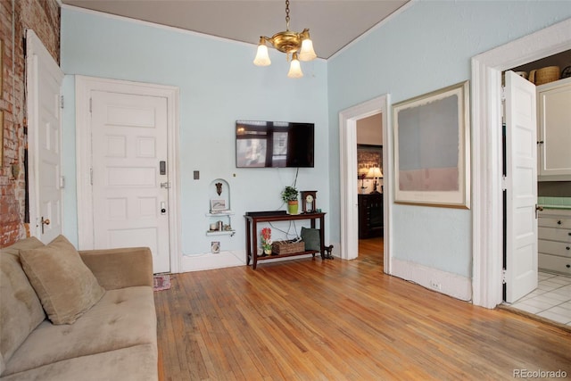 living room featuring light hardwood / wood-style flooring and an inviting chandelier