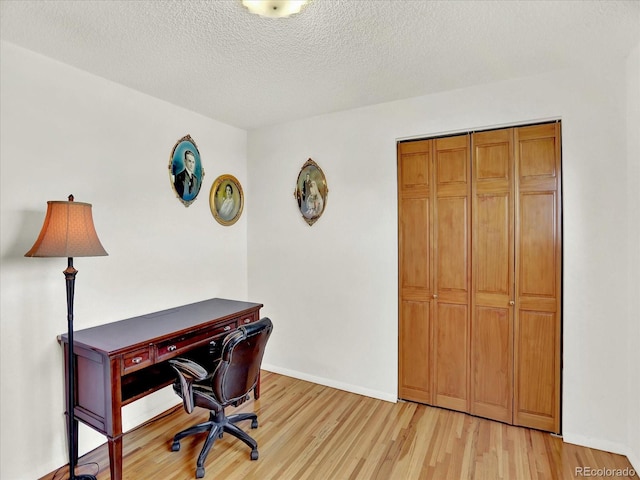 12798 Tomahawk Rd, Parker, CO 80138 - home office with baseboards, a textured ceiling, and light wood-style flooring