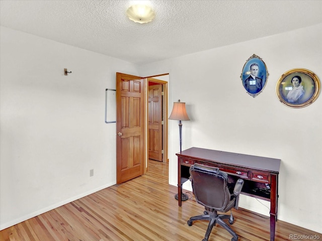 12798 Tomahawk Rd, Parker, CO 80138 - office area with baseboards, light wood-style floors, and a textured ceiling
