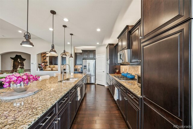 27423 E Euclid Dr, Aurora, CO 80016 - kitchen featuring a sink, appliances with stainless steel finishes, light stone counters, dark wood-type flooring, and dark brown cabinets