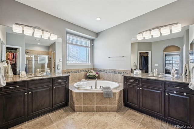 27423 E Euclid Dr, Aurora, CO 80016 - full bathroom with a shower stall, a bath, two vanities, healthy amount of natural light, and recessed lighting