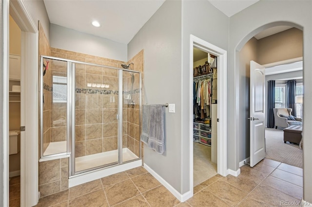 27423 E Euclid Dr, Aurora, CO 80016 - full bath with a stall shower, tile patterned flooring, baseboards, a spacious closet, and recessed lighting