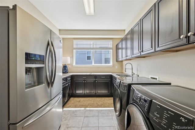 27423 E Euclid Dr, Aurora, CO 80016 - clothes washing area featuring separate washer and dryer, light tile patterned floors, and cabinet space