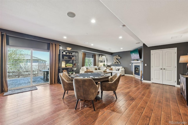 27423 E Euclid Dr, Aurora, CO 80016 - dining space featuring healthy amount of natural light, wood finished floors, a glass covered fireplace, recessed lighting, and baseboards
