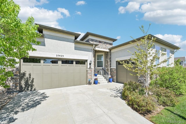 27423 E Euclid Dr, Aurora, CO 80016 - prairie-style home with stone siding, stucco siding, concrete driveway, and a garage