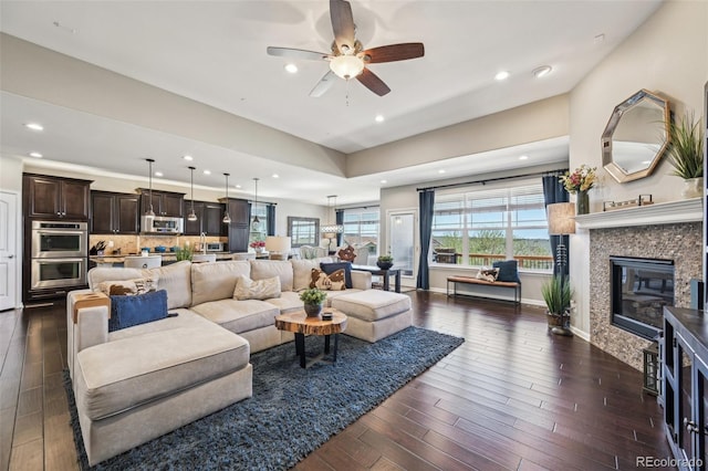 27423 E Euclid Dr, Aurora, CO 80016 - living room with ceiling fan, dark wood-style floors, recessed lighting, and a glass covered fireplace