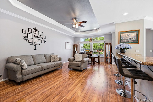 6231 Indian Paintbrush St Unit 214, Frederick, CO 80530 - living room featuring a tray ceiling, a ceiling fan, light wood finished floors, recessed lighting, and ornamental molding