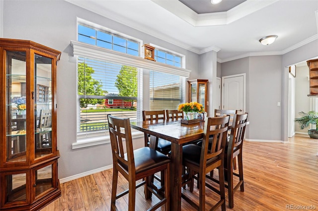 6231 Indian Paintbrush St Unit 214, Frederick, CO 80530 - dining room featuring light wood-style floors, healthy amount of natural light, ornamental molding, and baseboards