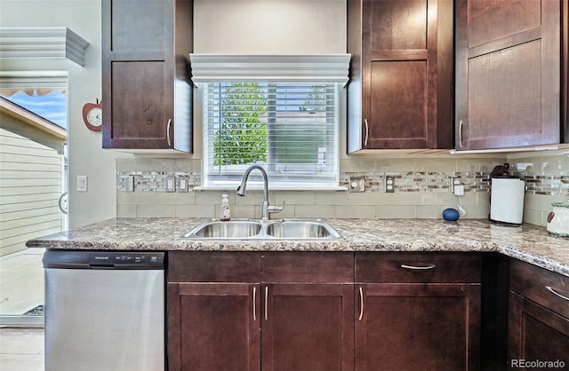 6231 Indian Paintbrush St Unit 214, Frederick, CO 80530 - kitchen featuring dishwasher, a sink, tasteful backsplash, dark brown cabinetry, and light stone counters