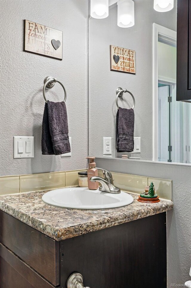 6231 Indian Paintbrush St Unit 214, Frederick, CO 80530 - bathroom with vanity and a textured wall