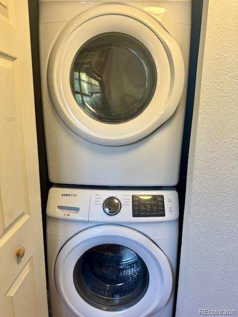 laundry room featuring stacked washer and dryer