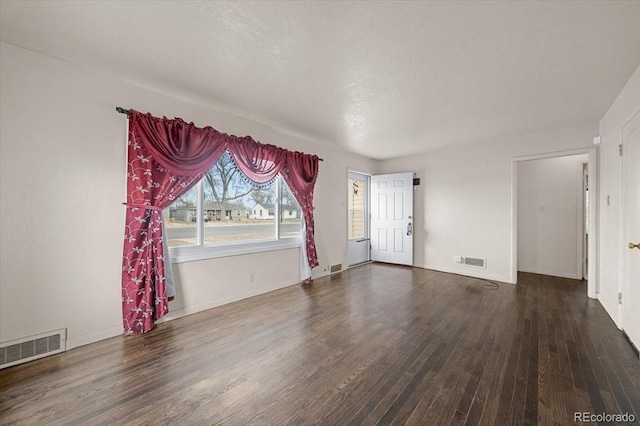 spare room with dark wood-type flooring