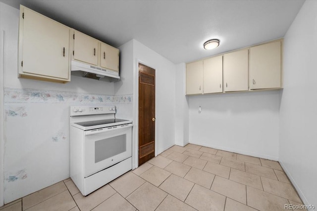 kitchen with electric range, light tile patterned flooring, and cream cabinetry