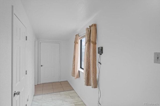 hall featuring light tile patterned flooring