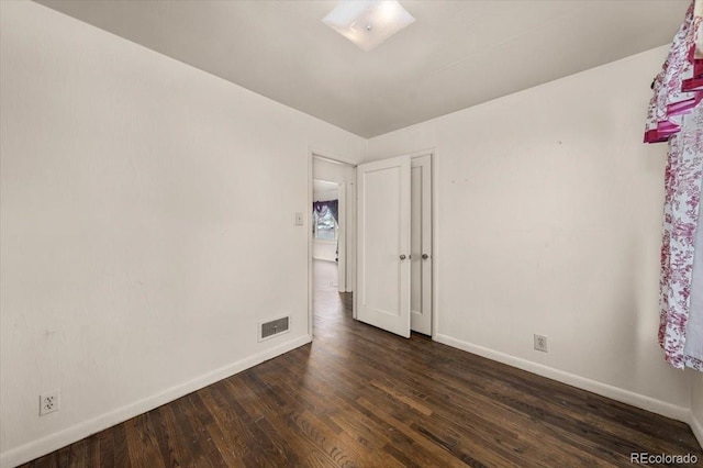 unfurnished room with dark hardwood / wood-style floors