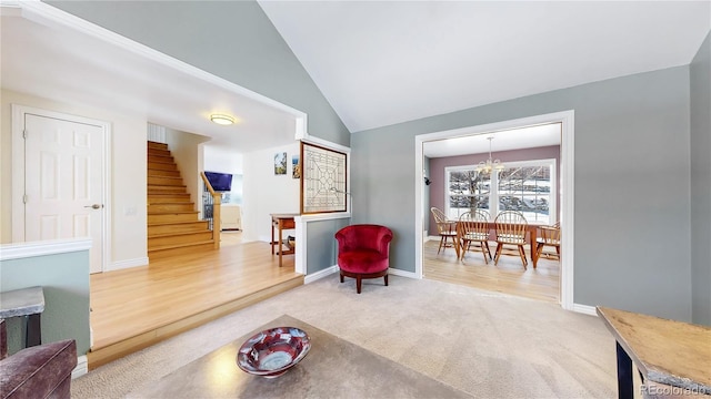 living area featuring lofted ceiling, stairway, carpet floors, baseboards, and a chandelier